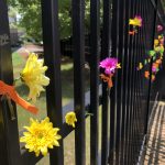 Fence covered with colorful flowers